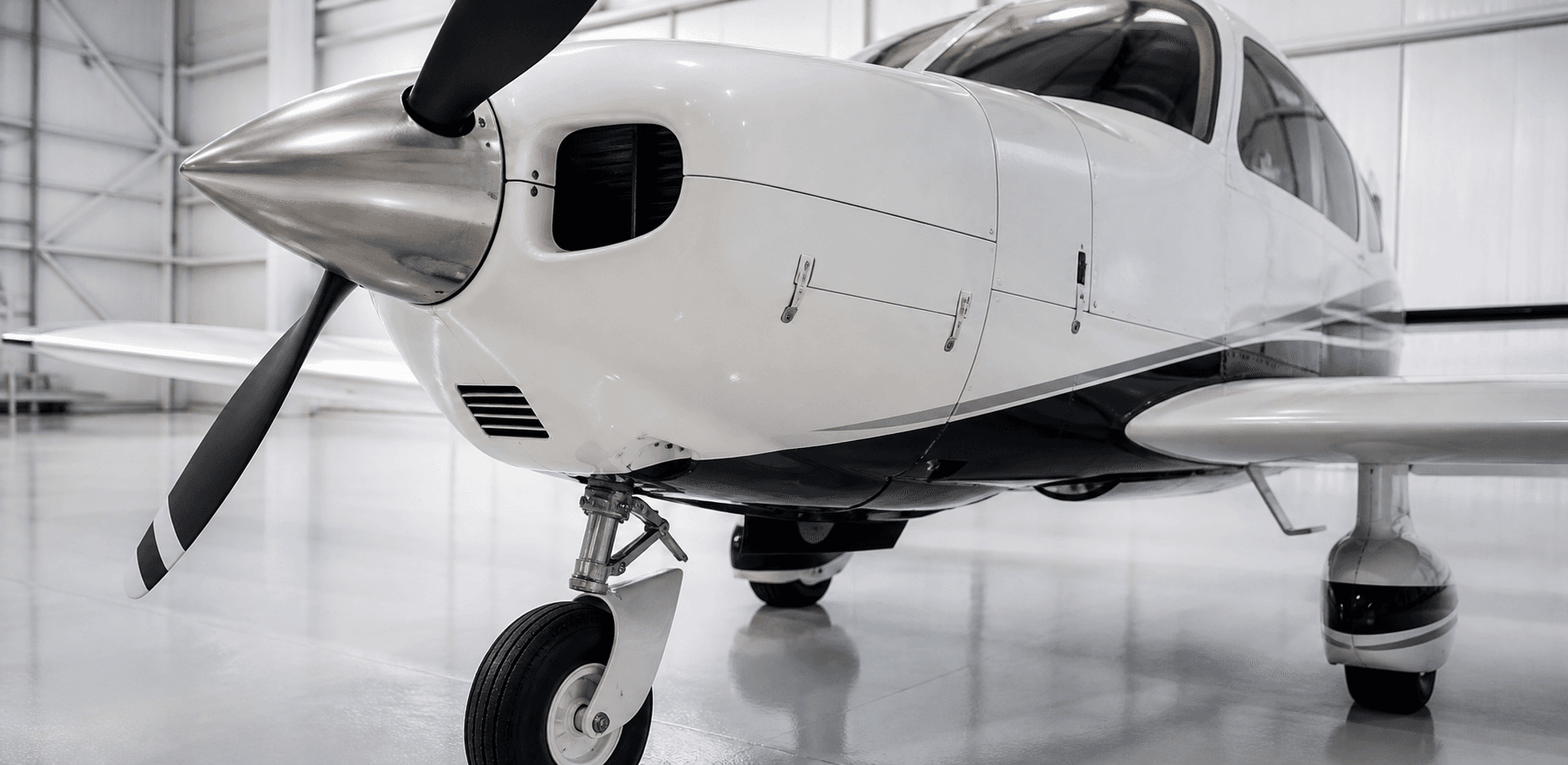 Details of a light aircraft in a bright hangar